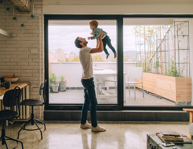 Father and son playing together in their living room