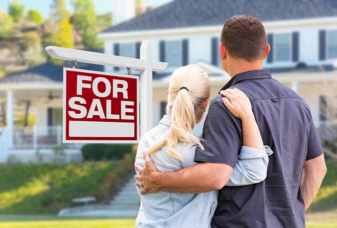 Couple looks at the home they’ve just listed for sale.