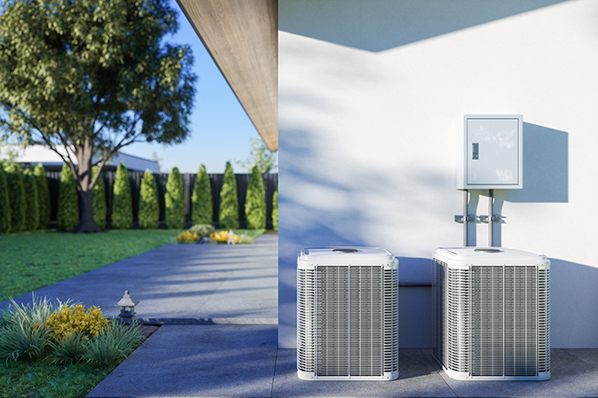 Double set of new AC units on side of house