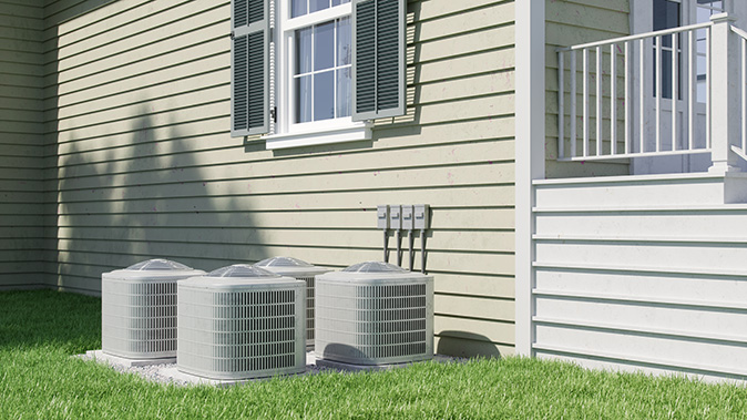 Exterior view of home with multiple AC units near a side wall