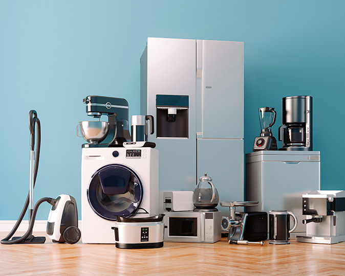 A variety of new appliances are set up for a sale.
