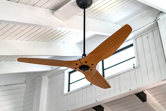 Modern 3-blade ceiling fan on a white ceiling
