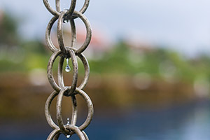 Example of a link-style rain chain attached to a roof