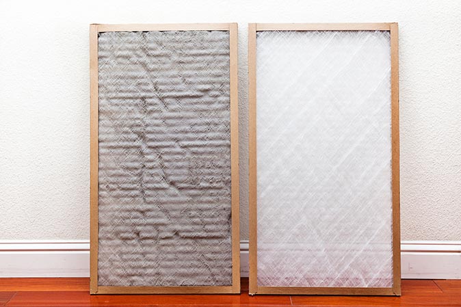 A side-by-side-comparison of a dirty air filter and a new, clean one 