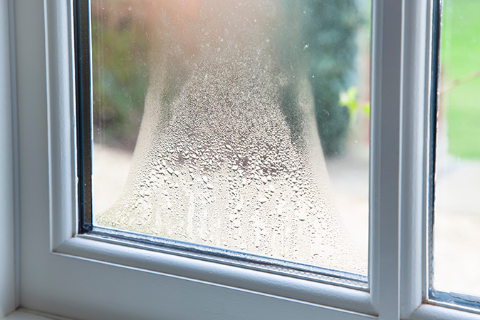 Condensation sits between the double-pane glass indicating that it's time to replace the windows.