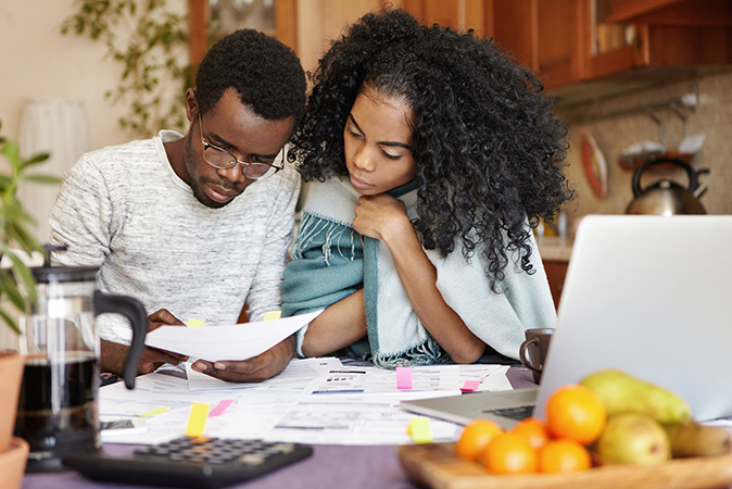 A couple sits down over breakfast to go over their mortgage terms.