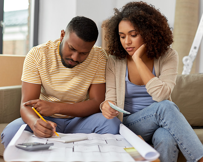 A young couple takes a coffee break during a DIY renovation project.