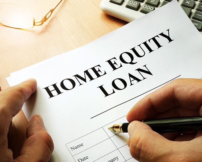 A homeowner fills out a form to apply for a home equity loan.
