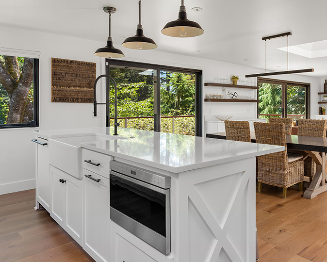 A built-in microwave installed in a farmhouse-style kitchen island counter.