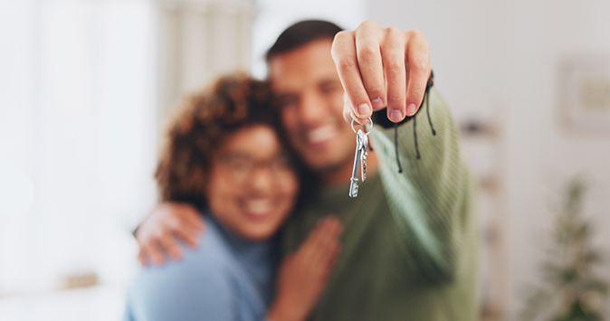 A proud couple show off the keys to their new home.