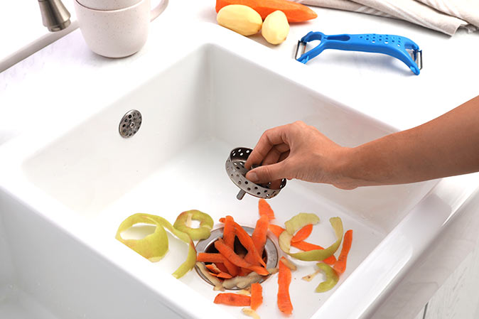 Sink full of scraps going down garbage disposal