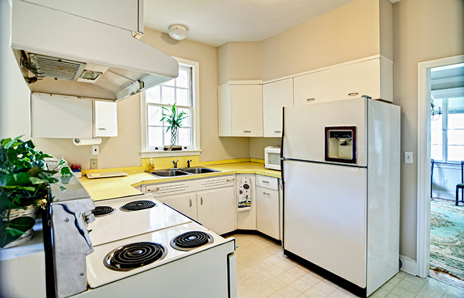 A kitchen with outdated appliances.