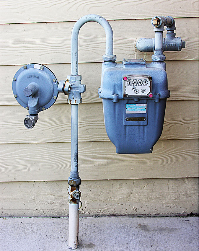 A typical natural gas meter outside a home.