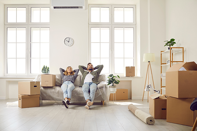 Finished with the home closing process, a young couple relaxes in their new home.