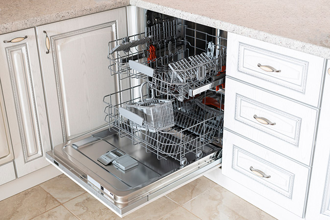 A new, open dishwasher in a kitchen.
