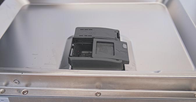 A dishwasher tablet sitting in the dispenser.