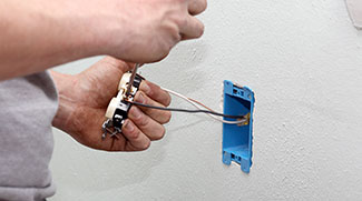 Homeowner in process of removing electrical outlet for one with USB ports