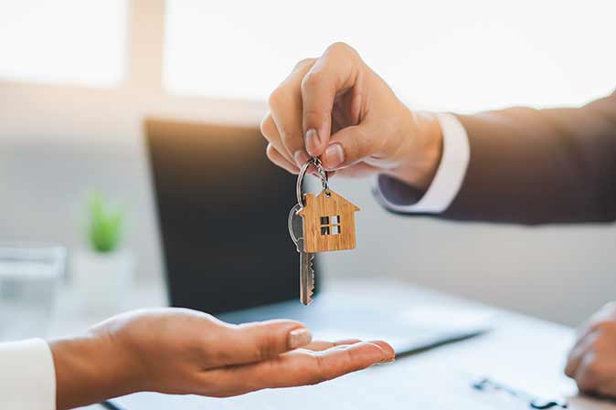 A person being handed the keys to their new home.