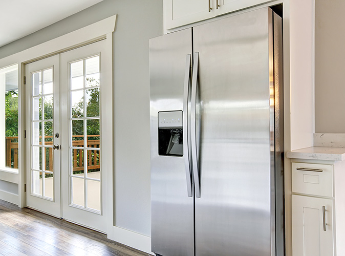 A stainless-steel refrigerator in a kitchen.