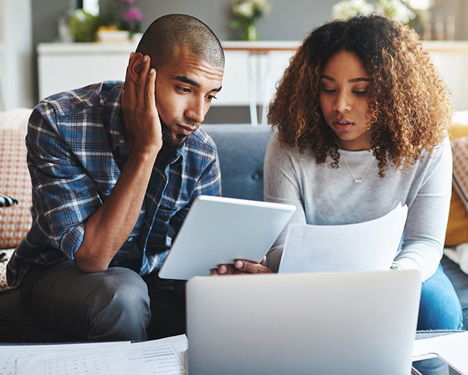 Couple reviewing title insurance documents to secure their home purchase.