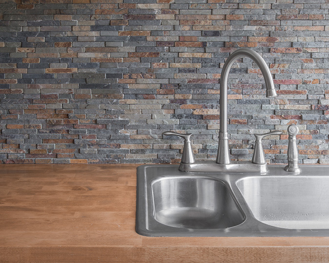 Black and white patterned backsplash in a modern luxury kitchen.