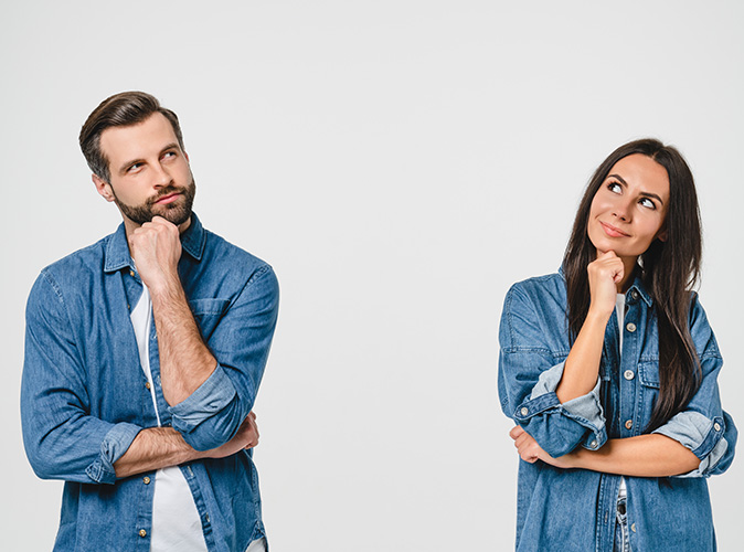 A couple stand next to each other as they consider home improvement options.