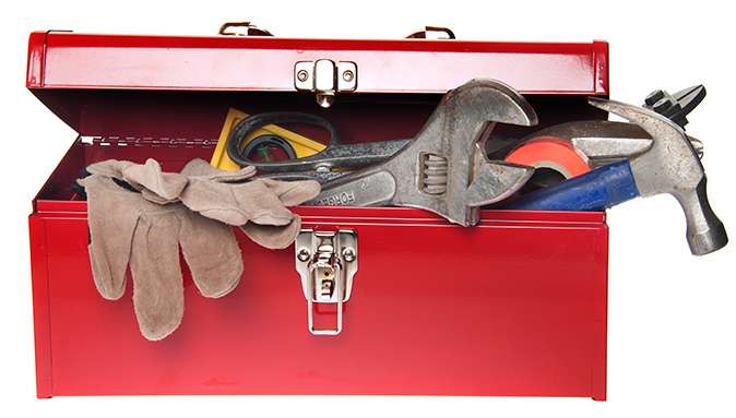 Open red toolbox containing gloves, wrench, hammer, and more.