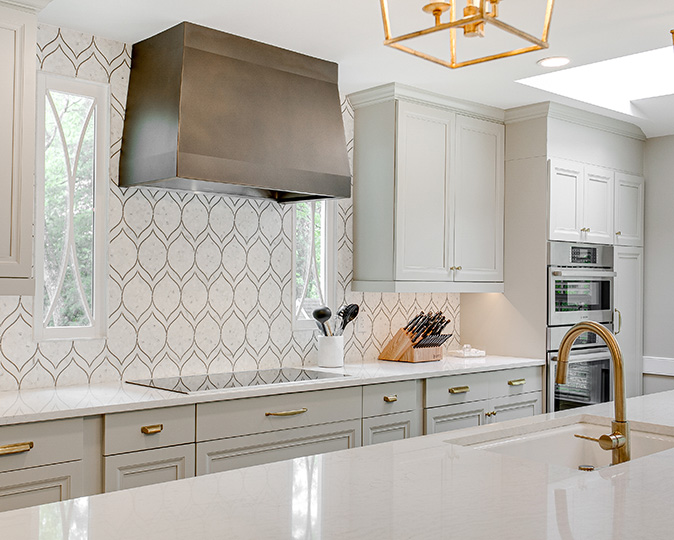 Black and white patterned backsplash in a modern luxury kitchen.