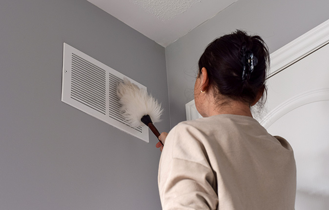 https://homewarranty.firstam.com/media/images/blog/posts/woman-cleaning-air-ducts674.jpg